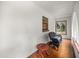 Sunroom with dark wicker chair and small round wooden table on tiled floor at 16891 Ne 243Rd Place Rd, Fort Mc Coy, FL 32134