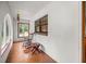 Cozy sunroom with tile floors, rocking chair, and windows providing natural light at 16891 Ne 243Rd Place Rd, Fort Mc Coy, FL 32134