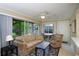Comfortable living room with screened lanai access and view of lush greenery at 20800 River Dr # A11, Dunnellon, FL 34431