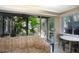 Bright and airy living room with a screened patio overlooking lush surroundings at 20800 River Dr # A11, Dunnellon, FL 34431