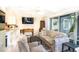 Inviting living room with cozy furniture, TV, and access to screened lanai with lake views at 20800 River Dr # A11, Dunnellon, FL 34431