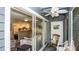 Cozy covered patio with ceiling fan, rocking chair, and sliding glass door to living area at 20800 River Dr # A11, Dunnellon, FL 34431
