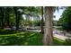 Tranquil waterfront with a wooden dock and lush green lawn at 20800 River Dr # A11, Dunnellon, FL 34431