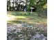 View of backyard with sparse grass and some mature trees at 2138 Sw 9Th Rd, Ocala, FL 34471
