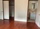 Bedroom featuring hardwood floors, closet, and doorway to an attached bathroom at 2138 Sw 9Th Rd, Ocala, FL 34471