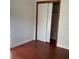Bedroom with wood floors and a closet featuring bi-fold doors at 2138 Sw 9Th Rd, Ocala, FL 34471