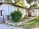 Exterior shot of home with a fenced yard, landscaping, and multiple entry points at 2138 Sw 9Th Rd, Ocala, FL 34471