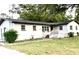 Charming single-story home with a white exterior, dark roof, cozy front porch, and well-maintained lawn at 2138 Sw 9Th Rd, Ocala, FL 34471