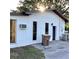 Back of home featuring exterior doors, windows and a large trash receptacle at 2138 Sw 9Th Rd, Ocala, FL 34471