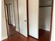 An interior hallway features beautiful hardwood floors and multiple closet doors, maximizing storage and space at 2138 Sw 9Th Rd, Ocala, FL 34471
