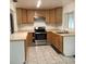 Classic kitchen with light wood cabinets and modern stainless steel appliances at 2138 Sw 9Th Rd, Ocala, FL 34471