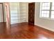Inviting living room features built-in bookshelves, a rich hardwood floor, and a solid wood front door at 2138 Sw 9Th Rd, Ocala, FL 34471