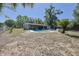 Spacious backyard featuring a refreshing pool, outdoor seating, and mature trees at 2808 Ne 24Th Ct, Ocala, FL 34470