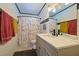 Bright bathroom with a modern vanity, sleek fixtures, and charming decorative shower curtain at 2808 Ne 24Th Ct, Ocala, FL 34470