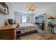 Relaxing bedroom complete with TV, dresser, and comfortable gray upholstered bed at 2808 Ne 24Th Ct, Ocala, FL 34470
