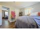 Comfortable bedroom features wood-look floors and a view to an additional bedroom at 2808 Ne 24Th Ct, Ocala, FL 34470