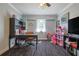 Spacious bedroom features a ceiling fan, window, and a stylish desk area at 2808 Ne 24Th Ct, Ocala, FL 34470
