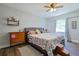 Comfortable bedroom featuring a cozy bed, wood-look flooring and natural light at 2808 Ne 24Th Ct, Ocala, FL 34470