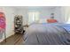 Comfortable bedroom features wood-look floors, ample natural light, and unique shoe storage at 2808 Ne 24Th Ct, Ocala, FL 34470