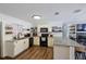 Bright kitchen featuring white cabinets, granite countertops, stainless steel appliances, and subway tile backsplash at 2808 Ne 24Th Ct, Ocala, FL 34470
