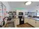 Bright kitchen featuring white cabinets, granite countertops, stainless steel appliances, and subway tile backsplash at 2808 Ne 24Th Ct, Ocala, FL 34470