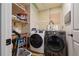 Efficient laundry room with modern washer and dryer and practical shelving at 2808 Ne 24Th Ct, Ocala, FL 34470