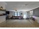 Open-concept living area with wood floors, a kitchen island, and a comfortable leather sectional sofa at 2808 Ne 24Th Ct, Ocala, FL 34470