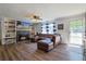 Cozy living room features a fireplace, built-in shelves, a ceiling fan, and a comfortable brown leather couch at 2808 Ne 24Th Ct, Ocala, FL 34470