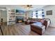 Inviting living room features a cozy fireplace, built-in bookshelves, and a comfortable leather sectional at 2808 Ne 24Th Ct, Ocala, FL 34470