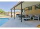 Relaxing pool patio features comfortable seating and a covered area for shade at 2808 Ne 24Th Ct, Ocala, FL 34470