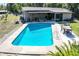 Aerial view of a sparkling pool with outdoor dining and patio seating, perfect for entertaining at 2808 Ne 24Th Ct, Ocala, FL 34470