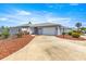 Charming single-story home with a well-maintained front yard and a two-car garage at 3017 Moultrie Way, The Villages, FL 32162