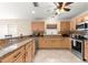Spacious kitchen with granite countertops, stainless steel appliances, and ample cabinet space at 3017 Moultrie Way, The Villages, FL 32162