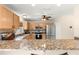 Open-concept kitchen with a breakfast bar, stainless appliances, and a tile floor at 3017 Moultrie Way, The Villages, FL 32162