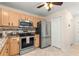 Well-appointed kitchen featuring stainless steel appliances and tile backsplash at 3017 Moultrie Way, The Villages, FL 32162