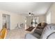 Spacious living room with tile flooring, neutral paint, and access to other rooms in the house at 3017 Moultrie Way, The Villages, FL 32162
