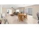 Open living room and dining area with tile flooring and lots of natural light at 3017 Moultrie Way, The Villages, FL 32162