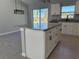 Kitchen island with granite countertop and views of the dining and living room area at 4573 Sw Carnation Ct, Dunnellon, FL 34431