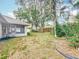 Backyard view with mature landscaping and a view of the screened-in porch at 5327 Sw 89Th St, Ocala, FL 34476