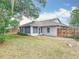 Backyard view of the home with a screened porch and a wooden fence at 5327 Sw 89Th St, Ocala, FL 34476