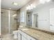 Bathroom featuring a glass shower and granite topped vanity at 5327 Sw 89Th St, Ocala, FL 34476