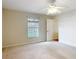 Bright bedroom with a ceiling fan and a sun-filled window at 5327 Sw 89Th St, Ocala, FL 34476