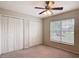 Neutral bedroom with a ceiling fan and a double closet at 5327 Sw 89Th St, Ocala, FL 34476