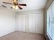 Neutral bedroom featuring a ceiling fan and a double closet at 5327 Sw 89Th St, Ocala, FL 34476