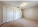 Bedroom featuring a double closet and neutral carpet at 5327 Sw 89Th St, Ocala, FL 34476