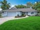Charming single-story home with a well-manicured lawn, lush greenery, and a two-car garage at 5327 Sw 89Th St, Ocala, FL 34476