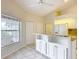 Bright kitchen with white cabinets, granite countertops, and a spacious breakfast bar island at 5327 Sw 89Th St, Ocala, FL 34476