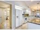 Spacious kitchen featuring stainless appliances, white cabinets, granite countertops and tile flooring at 5327 Sw 89Th St, Ocala, FL 34476