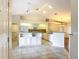 Open kitchen featuring white cabinetry, tile flooring, granite countertops, and stainless steel appliances at 5327 Sw 89Th St, Ocala, FL 34476