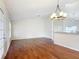 Living room with hardwood floors and an elegant chandelier at 5327 Sw 89Th St, Ocala, FL 34476